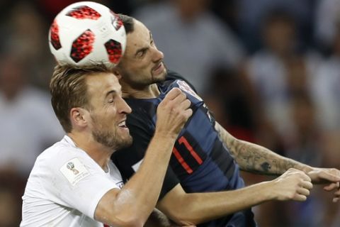 England's Harry Kane, left, challenges for the ball Croatia's Marcelo Brozovic, right, during the semifinal match between Croatia and England at the 2018 soccer World Cup in the Luzhniki Stadium in Moscow, Russia, Wednesday, July 11, 2018. (AP Photo/Francisco Seco)