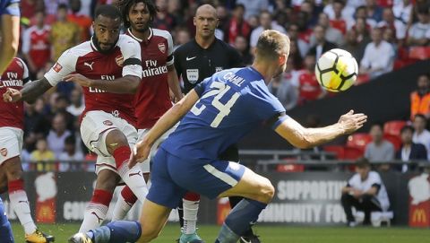 Arsenal'sAlexandre Lacazette, left , shoots on goal during the English Community Shield soccer match between Arsenal and Chelsea at Wembley Stadium in London, Sunday, Aug. 6, 2017. (AP Photo/Frank Augstein)