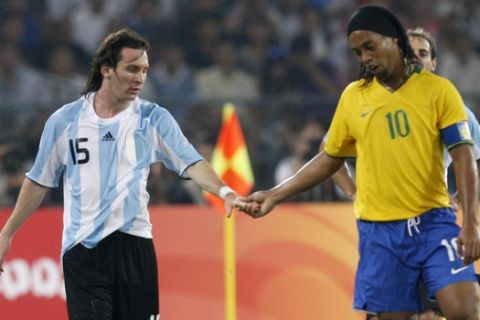 Argentina's Lionel Messi, left, and Brazil's Ronaldinho shake hands during their men's semifinal soccer match at the Beijing 2008 Olympics in Beijing, Tuesday, Aug. 19, 2008. (AP Photo/Luca Bruno)