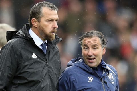 Fulham manager Slavisa Jokanovic, left, and assistant Javier Pereira talk, during the English Premier League soccer match between Fulham and Watford, at Craven Cottage, in London,  Saturday Sept. 22, 2018. (Chris Radburn/PA via AP)