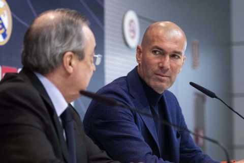 Zinedine Zidane looks at President of Real Madrid, Florentino Perez, left, during a press conference in Madrid, Spain, Thursday, May 31, 2018. Zidane quit as Real Madrid coach on Thursday, less than a week after leading the team to its third straight Champions League title, saying the club needed a change in command. (AP Photo/Borja B. Hojas)