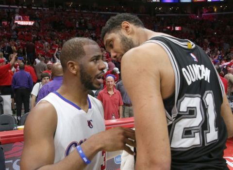 LOS ANGELES, CA - MAY 02:  Tim Duncan #21 of the San Antonio Spurs and Chris Paul #3 of the Los Angeles Clippers meet after Game Seven of the Western Conference quarterfinals of the 2015 NBA Playoffs at Staples Center on May 2, 2015 in Los Angeles, California.  The Clippers won 111-109 to win the series four games to three.  NOTE TO USER: User expressly acknowledges and agrees that, by downloading and or using this photograph, User is consenting to the terms and conditions of the Getty Images License Agreement.  (Photo by Stephen Dunn/Getty Images)