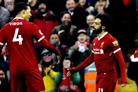 Liverpool's Mohamed Salah, right, celebrates with Virgil van Dijk after scoring his side's first goal during the English Premier League soccer match between Liverpool and Tottenham Hotspur at Anfield, Liverpool, England, Sunday, Feb. 4, 2018. (AP Photo/Rui Vieira)