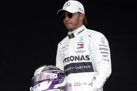 Mercedes driver Lewis Hamilton of Britain poses for a photo at the Australian Formula One Grand Prix in Melbourne, Thursday, March 12, 2020. (AP Photo/Rick Rycroft)