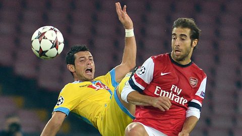 Arsenal's French midfielder Mathieu Flamini vies with Napoli's Swiss midfielder Blerim Dzemaili (L) during the UEFA Champions League group F football match between SSC Napoli and Arsenal FC at the San Paolo Stadium in Naples on December 11, 2013. AFP PHOTO / GABRIEL BOUYS        (Photo credit should read GABRIEL BOUYS/AFP/Getty Images)