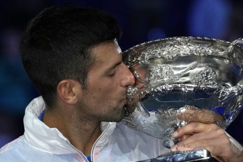 Novak Djokovic of Serbia kisses the Norman Brookes Challenge Cup after defeating Stefanos Tsitsipas of Greece in the men's singles final at the Australian Open tennis championship in Melbourne, Australia, Sunday, Jan. 29, 2023. (AP Photo/Aaron Favila)