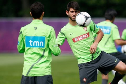 Nelson Oliveira kicks a ball back to teammate Ricardo Costa, left, during a training session of Portugal at the Euro 2012 soccer championship in Opalenica, Poland, Monday, June 11, 2012. (AP Photo/Armando Franca)