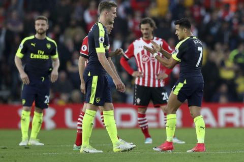 Arsenal's Alexis Sanchez, right, claps to rouse his teammates during the English Premier League soccer match between Southampton and Arsenal at St Mary's stadium in Southampton, England, Wednesday, May 10, 2017. (AP Photo/Alastair Grant)