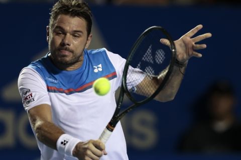 Switzerland's Stan Wawrinka returns a ball against Frances Tiafoe of the U.S. in Round 1 play at the Mexican Tennis Open in Acapulco, Mexico, Monday, Feb. 24, 2020.(AP Photo/Rebecca Blackwell)