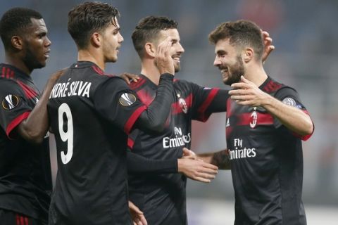 AC Milan's Patrick Cutrone, right, celebrates with his teammates after scoring during the Europa League group D soccer match between AC Milan and Austria Wien, at the San Siro stadium in Milan, Italy, Thursday, Nov. 23, 2017. (AP Photo/Antonio Calanni)