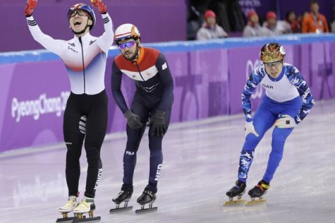 Lim Hyojun of South Korea celebrates after winning the men's 1500 meters short-track speedskating final ahead of Sjinkie Knegt of the Netherlands and Semen Elistratov of the Olympic Athletes of Russia in the Gangneung Ice Arena at the 2018 Winter Olympics in Gangneung, South Korea, Saturday, Feb. 10, 2018. (AP Photo/David J. Phillip)