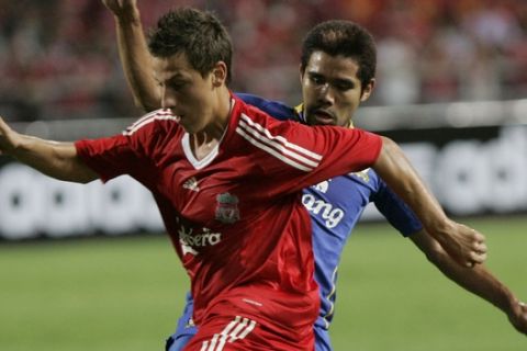 Liverpool's Krisztain Nemeth, front, vies for the ball with Thailand's Suree Sukha, back, during their friendly match at Rajamangala national stadium, Bangkok, Thailand, Wednesday, July 22, 2009. (AP Photo/Sakchai Lalit)