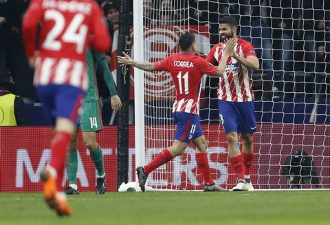 Atletico Madrid's Diego Costa, right, celebrates with Atletico Madrid's Angel Correa after scoring his side's second goal during the Europa League Round of 16 first leg soccer match between Atletico Madrid and Lokomotiv Moscow at the Metropolitano stadium in Madrid, Thursday, March 8, 2018. (AP Photo/Francisco Seco)