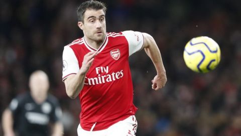 Arsenal's Sokratis Papastathopoulos eyes the ball during the English Premier League soccer match between Arsenal and Brighton, at the Emirates Stadium in London, Thursday, Dec. 5, 2019. (AP Photo/Frank Augstein)