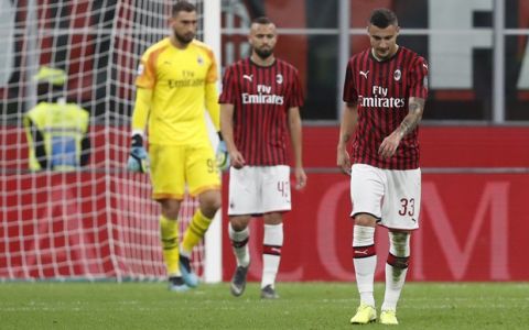 AC Milan's Rade Krunic, AC Milan's Leo Duarte, AC Milan's goalkeeper Gianluigi Donnarumma walk on the pitch in dejection after Fiorentina's Gaetano Castrovilli scored his side's second goal during a Serie A soccer match between AC Milan and Fiorentina, at the San Siro stadium in Milan, Italy, Sunday, Sept. 29, 2019. (AP Photo/Antonio Calanni)