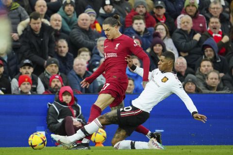 Manchester United's Marcus Rashford, right, challenges Liverpool's Darwin Nunez during the English Premier League soccer match between Liverpool and Manchester United at Anfield in Liverpool, England, Sunday, March 5, 2023. (AP Photo/Jon Super)