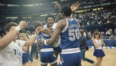 Memphis State Tiger players Baskerville Holmes (40), Dewayne Bailey, and William Bedford (50) celebrate after winning Saturday?s NCAA Midwest Regional Championship in Dallas on March 23, 1985. The Tigers beat the Oklahoma Sooners 63-61. (AP Photo/Bill Belknap)
