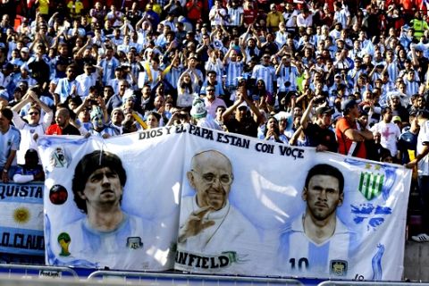 Argentina's fans hold a banner with the images of Argentina's Lionel Messi, right, Pope Francis, center, and Argentina's soccer legend Diego Maradona, during the final Copa America soccer match between Argentina and Chile at the National Stadium in Santiago, Chile, Saturday, July 4, 2015. (AP Photo/Ricardo Mazalan)
