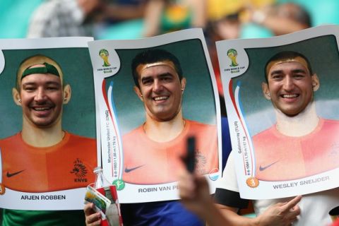 SALVADOR, BRAZIL - JUNE 13:  Fans wear cutout images of the Netherlands players before the 2014 FIFA World Cup Brazil Group B match between Spain and Netherlands at Arena Fonte Nova on June 13, 2014 in Salvador, Brazil.  (Photo by Quinn Rooney/Getty Images)