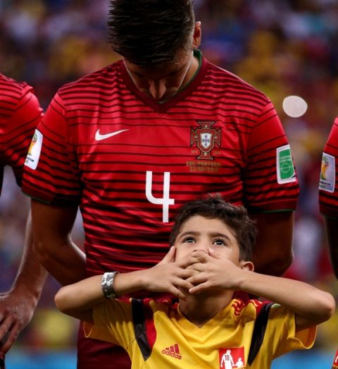 MANAUS, BRAZIL - JUNE 22: Miguel Veloso of Portugal and his player escort look on during the National Anthem prior to the 2014 FIFA World Cup Brazil Group G match between the United States and Portugal at Arena Amazonia on June 22, 2014 in Manaus, Brazil.  (Photo by Adam Pretty/Getty Images)