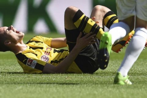 Dortmund's Julian Weigl is injured after a foul during the German Bundesliga soccer match between FC Augsburg and Borussia Dortmund at the WWK Arena in Augsburg, Germany, Saturday, May 13, 2017. (Andreas Gebert/dpa via AP)