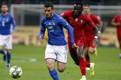Italy's Alessandro Florenzi, left, and Portugal's Bruma challenge for the ball during the UEFA Nations League soccer match between Italy and Portugal at the San Siro Stadium, in Milan, Saturday, Nov. 17, 2018. (AP Photo/Antonio Calanni)