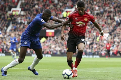Chelsea's Antonio Rudiger, left, and Manchester United's Marcus Rashford battle for the ball during their English Premier League soccer match at Old Trafford, Manchester, England, Sunday, April 28, 2019. (Martin Rickett/PA via AP)