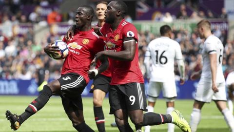 Manchester United's Eric Bailly, left, celebrates with teammate Romelu Lukaku after scoring his side's first goal during their English Premier League soccer match at the Liberty Stadium, Swansea, Wales, Saturday, Aug. 19, 2017. (Nick Potts/PA via AP)