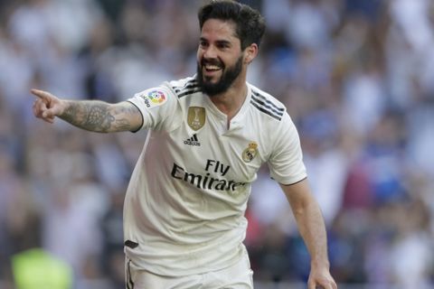 Real Madrid's Isco celebrates after scoring during a Spanish La Liga soccer match between Real Madrid and Celta at the Santiago Bernabeu stadium in Madrid, Spain, Saturday, March 16, 2019. At right his Real Madrid's Gareth Bale. (AP Photo/Paul White)