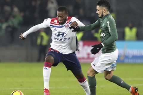 Lyon's Tanguy Ndombele Alvaro, left, challenges for the ball with Saint-Etienne's Remy Cabella, right, during their French League One soccer match in Saint-Etienne, central France, Sunday, Jan. 20, 2019. (AP Photo/Laurent Cipriani)