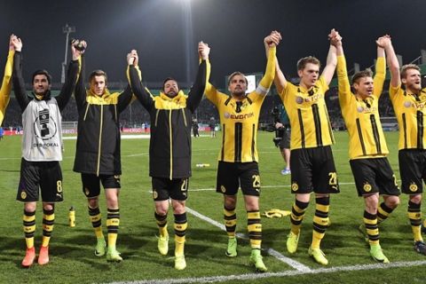 Dortmund's team celebrates after winning the German Soccer Cup quarterfinal match between SF Lotte and Borussia Dortmund in Osnabrueck, Germany, Tuesday, March 14, 2017. Lotte was defeated by Dortmund with 0-3. (AP Photo/Martin Meissner)