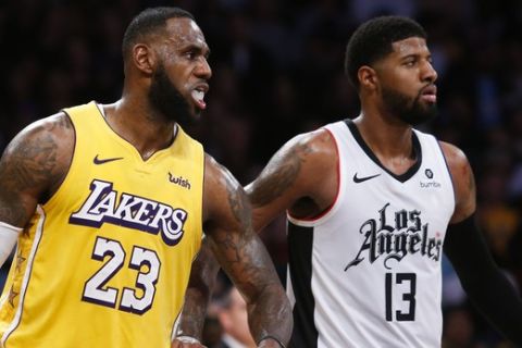 Los Angeles Lakers' LeBron James (23) and Los Angeles Clippers' Paul George (13) in an NBA basketball game between Los Angeles Lakers and Los Angeles Clippers, Wednesday, Dec. 25, 2019, in Los Angeles. The Clippers won 111-106. (AP Photo/Ringo H.W. Chiu)