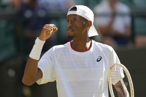 Christopher Eubanks of the US celebrates winning a point from Britain's Cameron Norrie during the men's singles match on day five of the Wimbledon tennis championships in London, Friday, July 7, 2023. (AP Photo/Alastair Grant)