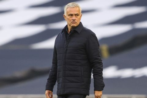 Tottenham's manager Jose Mourinho walks in the pitch prior the English Premier League soccer match between Tottenham Hotspur and Everton FC at the Tottenham Hotspur Stadium in London, England, Monday, July 6, 2020. (Richard Heathcote/Pool via AP)