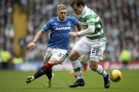 Celtic's Erik Sviatchenko, right, and Rangers' Martyn Waghorn battle for the ball during the Scottish Premiership soccer match at Celtic Park, Glasgow, Sunday March 12, 2017. (Jane Barlow/PA via AP)
