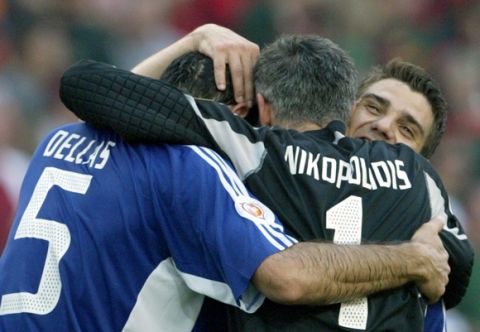 epa000210537 Greek players celebrate after the team defeated Portugal in the Group A match of the EURO 2004 at Estadio do Dragao in Porto, Saturday 12 June 2004.  Greece won 2-1.  At right is Portugal's Deco and far left captain Fernando Couto.  EPA/NUNO VEIGA NO MOBILEPHONE APPLICATIONS