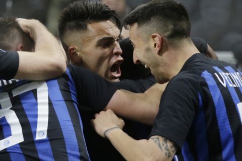 Inter Milan's Lautaro Martinez celebrates with his teammates after scoring during a Serie A soccer match between Inter Milan and Napoli, at the San Siro stadium in Milan, Italy, Wednesday, Dec.26, 2018. (AP Photo/Luca Bruno)