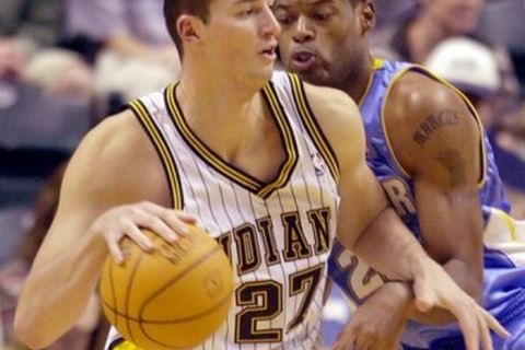 Indiana Pacers center Primoz Brezec, from Slovenia, backs in on Denver Nuggets center Marcus Camby during the first quarter of a preseason game in Indianapolis, Wednesday, Oct. 15, 2003. (AP Photo/Darron Cummings)
