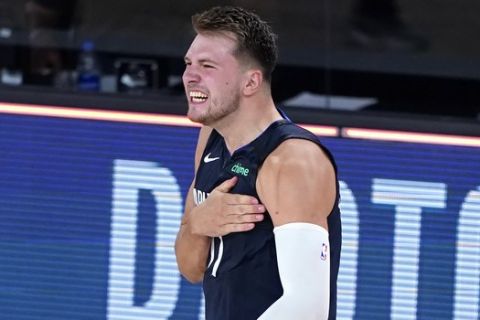 Dallas Mavericks' Luka Doncic celebrates after making a game-winning 3-point basket against the Los Angeles Clippers during overtime of an NBA basketball first round playoff game Sunday, Aug. 23, 2020, in Lake Buena Vista, Fla. The Mavericks won 135-133 in overtime. (AP Photo/Ashley Landis, Pool)