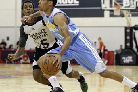 Denver Nuggets' Erick Green (11) drives against Milwaukee Bucks' Ish Smith in the second quarter of an NBA Summer League basketball game on Saturday, July 13, 2013, in Las Vegas. (AP Photo/Julie Jacobson)