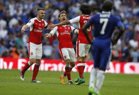 Arsenal's Nacho Monreal, center, celebrates at the end of the English FA Cup final soccer match between Arsenal and Chelsea at Wembley stadium in London, Saturday, May 27, 2017. Arsenal won 2-1. (AP Photo/Kirsty Wigglesworth)