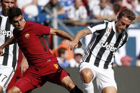 AS Roma's Diego Perotti, left, and Juventus' Claudio Marchisio, right, contend for the ball during the first half of an International Champions Cup match, Sunday, July 30, 2017, in Foxborough, Mass. (AP Photo/Michael Dwyer)