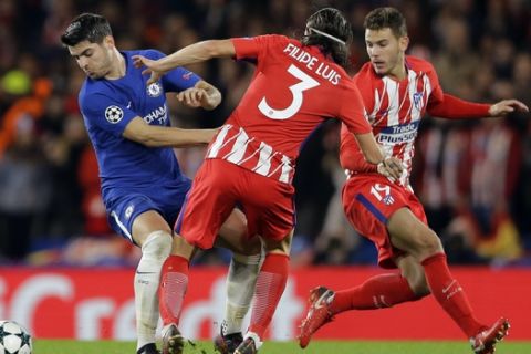 Chelsea's Alvaro Morata, left, competes for the ball with Atletico's Filipe Luis, centre, and Atletico's Lucas, right, during the Champions League Group C soccer match between Chelsea and Atletico Madrid at Stamford Bridge stadium in London Tuesday, Dec. 5, 2017. (AP Photo/Alastair Grant)