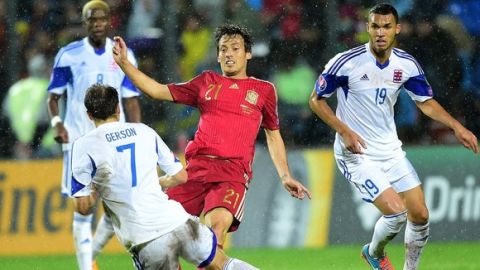 Spain's David Silva (C) and Luxembourg's Lars Gerson fight the ball during the Group C Euro 2016 qualifying football match between Luxembourg and Spain at the Josy Barthel stadium in Luxembourg , on October 12, 2014. AFP PHOTO/EMMANUEL DUNAND        (Photo credit should read EMMANUEL DUNAND/AFP/Getty Images)