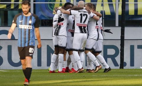 Udinese's Kevin Lasagna, covers his teammates, celebrates after scoring his side's opening goal during the Serie A soccer match between Inter Milan and Udinese at the San Siro stadium in Milan, Italy, Saturday, Dec. 16, 2017. (AP Photo/Antonio Calanni)