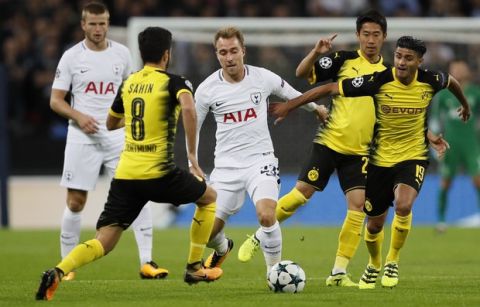 Tottenham's Christian Eriksen, center, challenges for the ball with Dortmund's Nuri Sahin, left, Shinji Kagawa and Mahmoud Dahoud during the Champions League group H soccer match between Tottenham and Borussia Dortmund, at the Wembley stadium in London, Wednesday, Sept. 13, 2017. (AP Photo/Kirsty Wigglesworth)