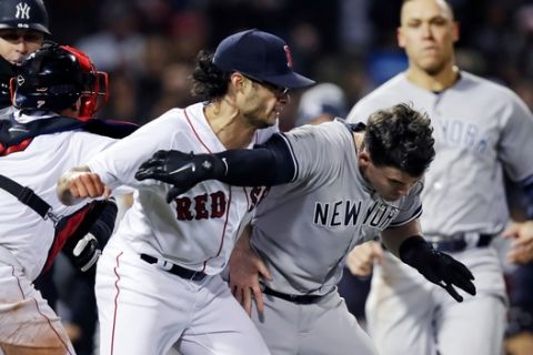 New York Yankees' Tyler Austin, right, scuffles with Boston Red Sox relief pitcher Joe Kelly, after being hit by a pitch during the seventh inning of a baseball game at Fenway Park in Boston, Wednesday, April 11, 2018. (AP Photo/Charles Krupa)