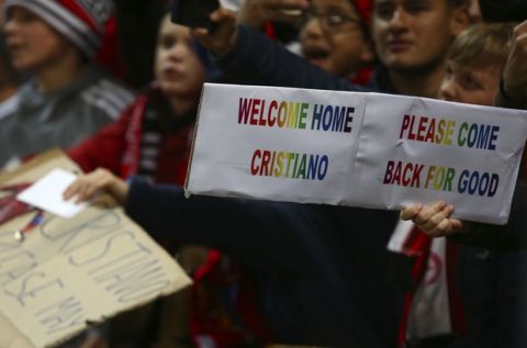 A fan holds a sign for Juventus forward Cristiano Ronaldo during the Champions League group H soccer match between Manchester United and Juventus at Old Trafford, Manchester, England, Tuesday, Oct. 23, 2018. (AP Photo/Dave Thompson)