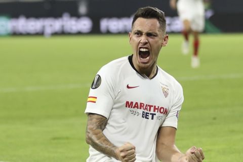 Sevilla's Lucas Ocampos celebrates after scoring his side's opening goal during the Europa League quarterfinal soccer match between Wolves and Sevilla at the MSV Arena in Duisburg, Germany, Tuesday, Aug. 11, 2020. (Friedemann Vogel, Pool Photo via AP)