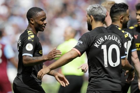 Manchester City's Raheem Sterling, left, celebrates with Sergio Aguero after scoring his side's third goal during the English Premier League soccer match between West Ham United and Manchester City at London stadium in London, Saturday, Aug. 10, 2019. (AP Photo/Kirsty Wigglesworth)